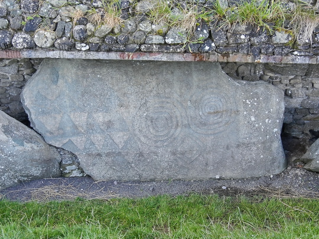 a stone wall with a carved face,