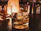 A sleek whiskey glass set displayed on a polished wooden bar with soft ambient lighting.