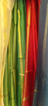 Colorful array of jaluzele samples hanging in a bright, contemporary showroom.