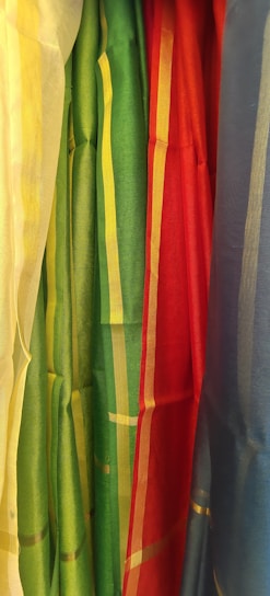 A collection of roman blinds in various fabrics and colors.