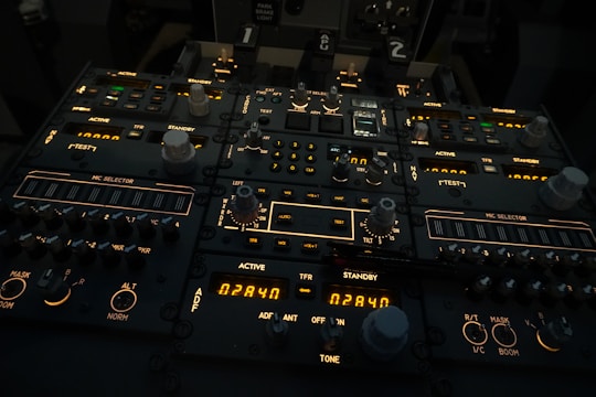 A close-up of a complex ground support control panel with illuminated indicators.