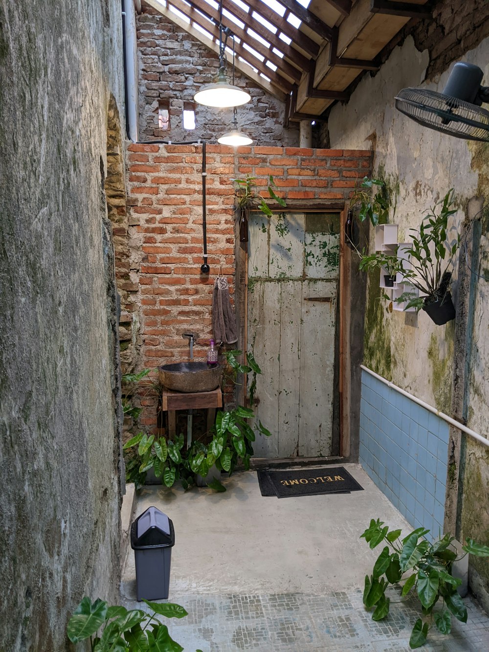 a brick building with a sink and a door