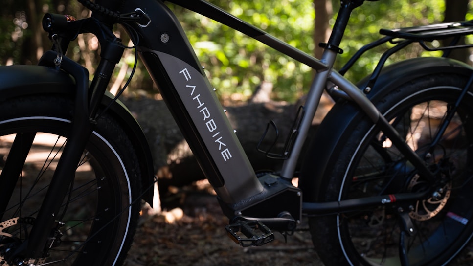 A close-up of an electric bike parked on a scenic trail.