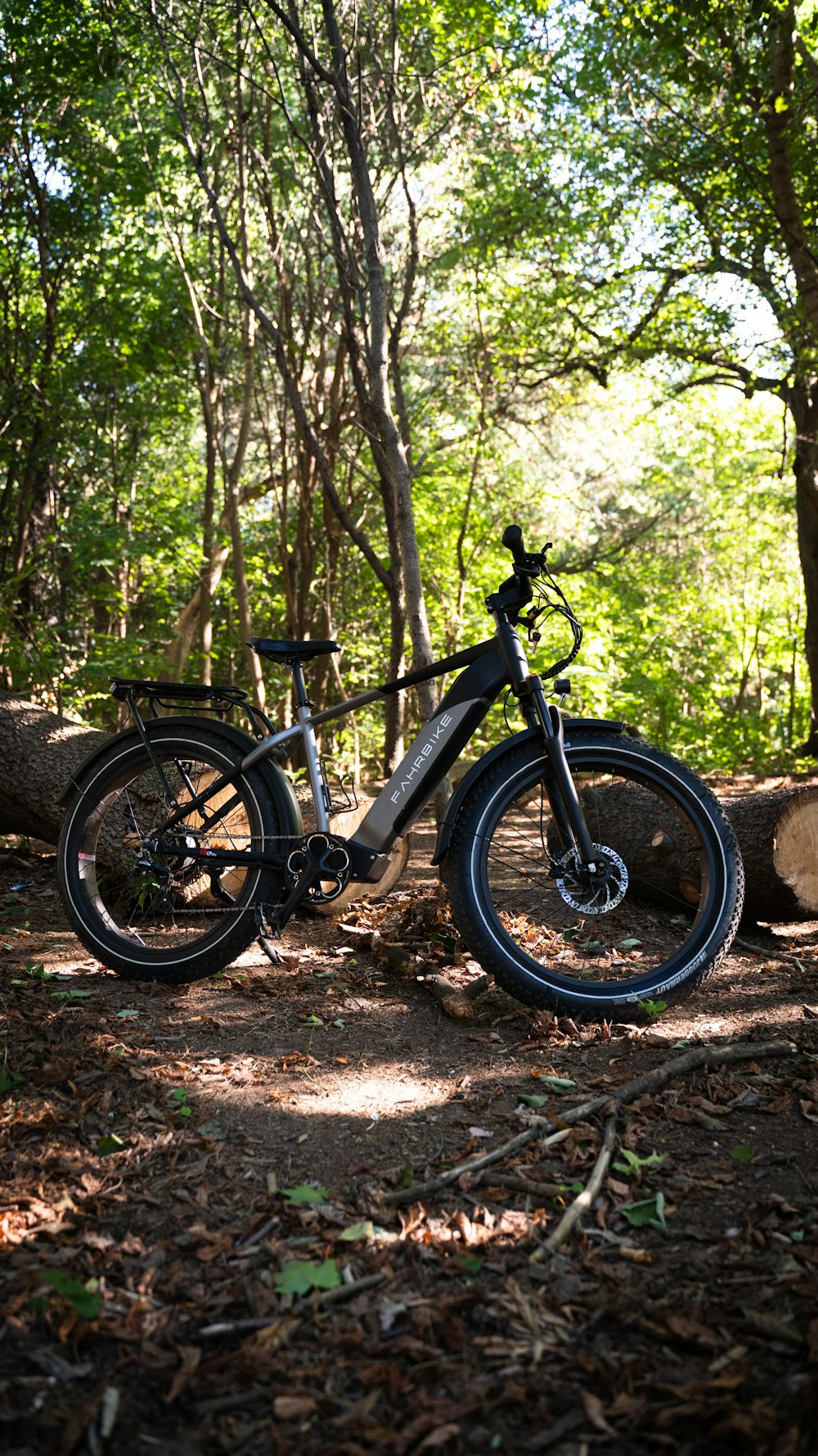 a bicycle parked in the woods