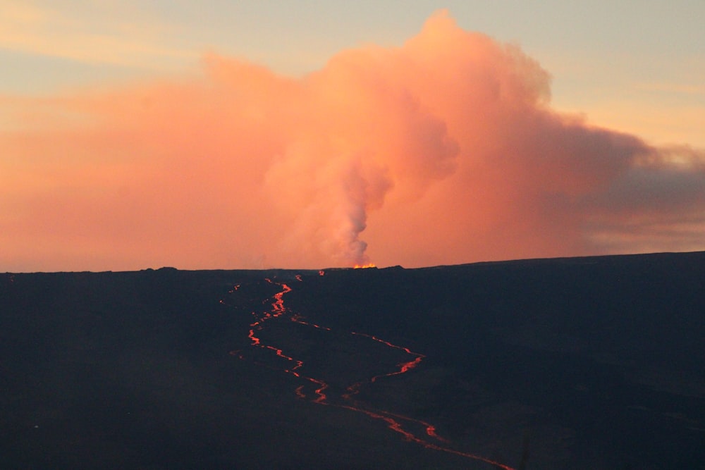 a volcano erupting at sunset