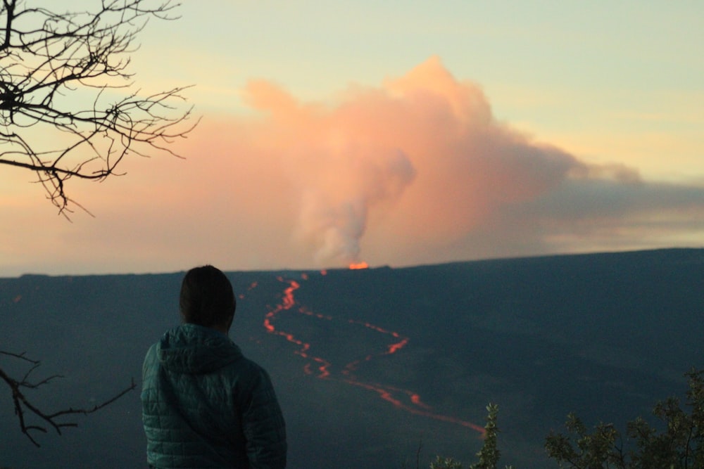 a person looking at a large fire