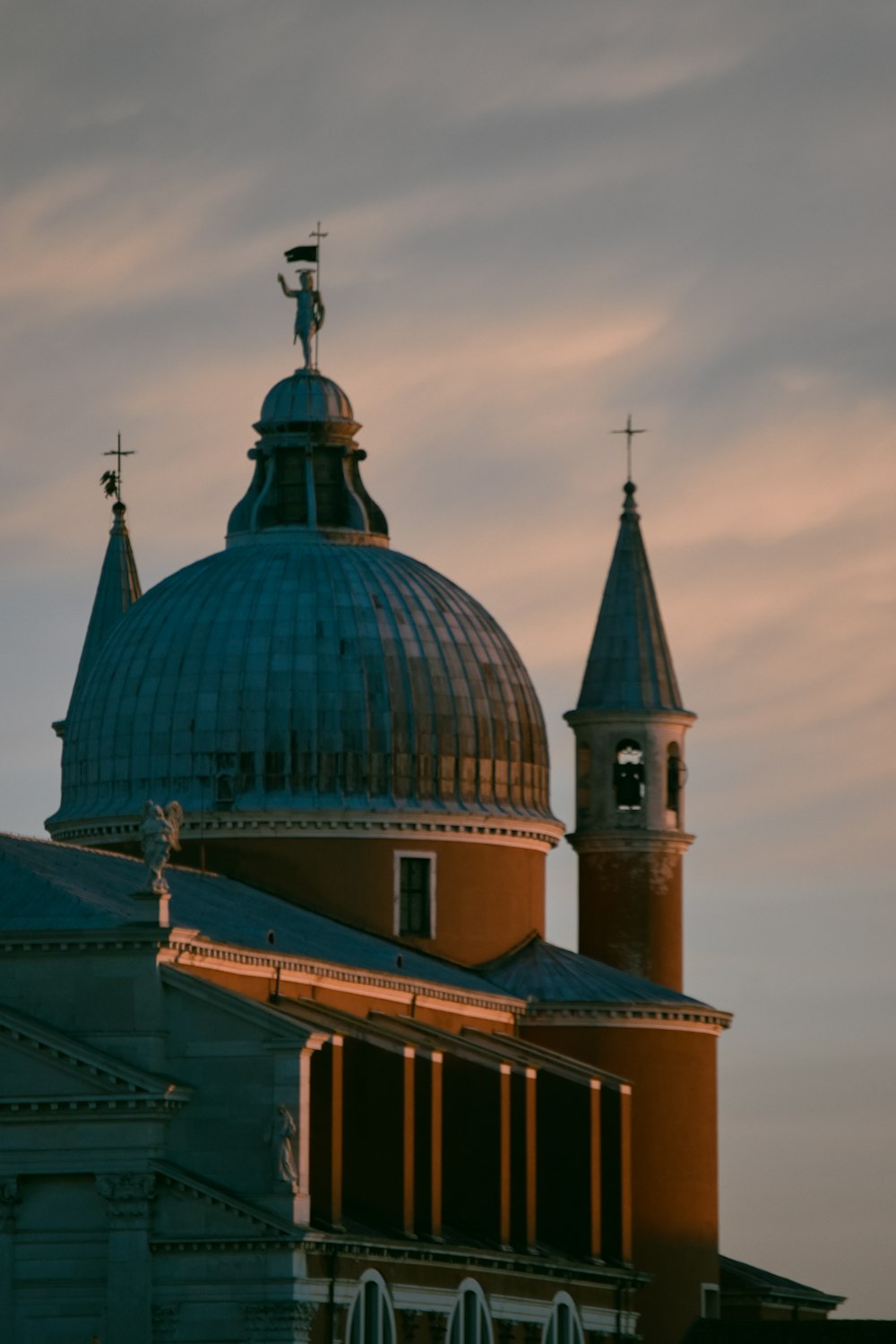 a building with a blue dome and a cross on top