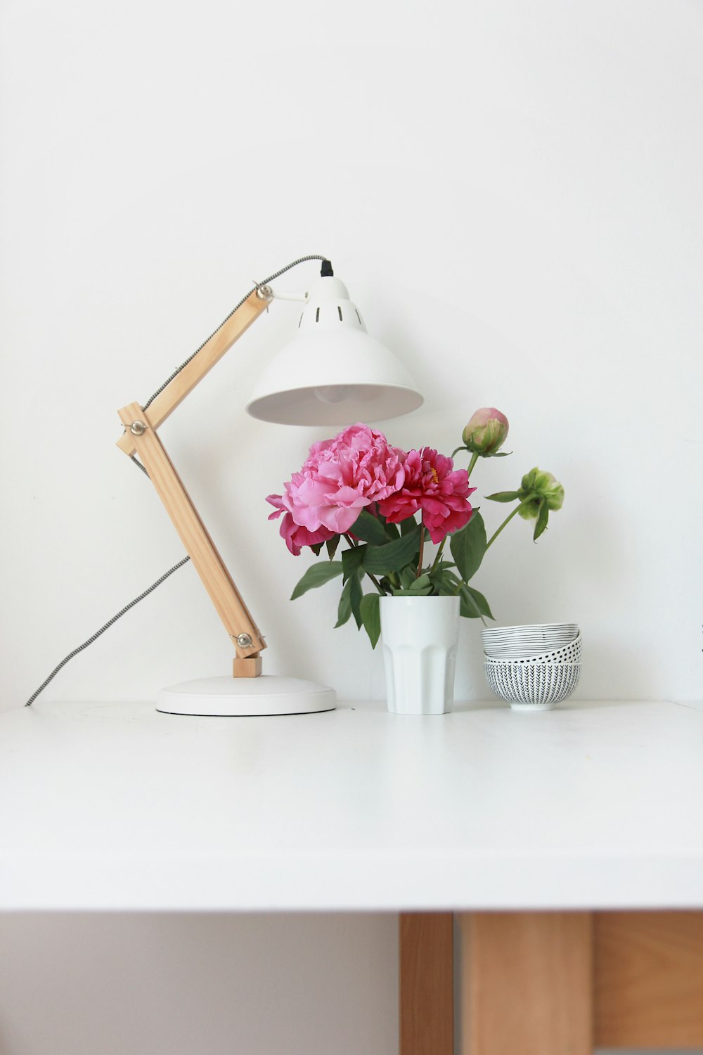 a lamp and flowers on a table