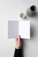 A folded Christmas card open to reveal blank inner pages ready for personal messages.
