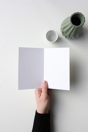 a hand holding a piece of paper