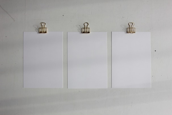 Various sizes of paper corner protectors arranged on a clean white surface