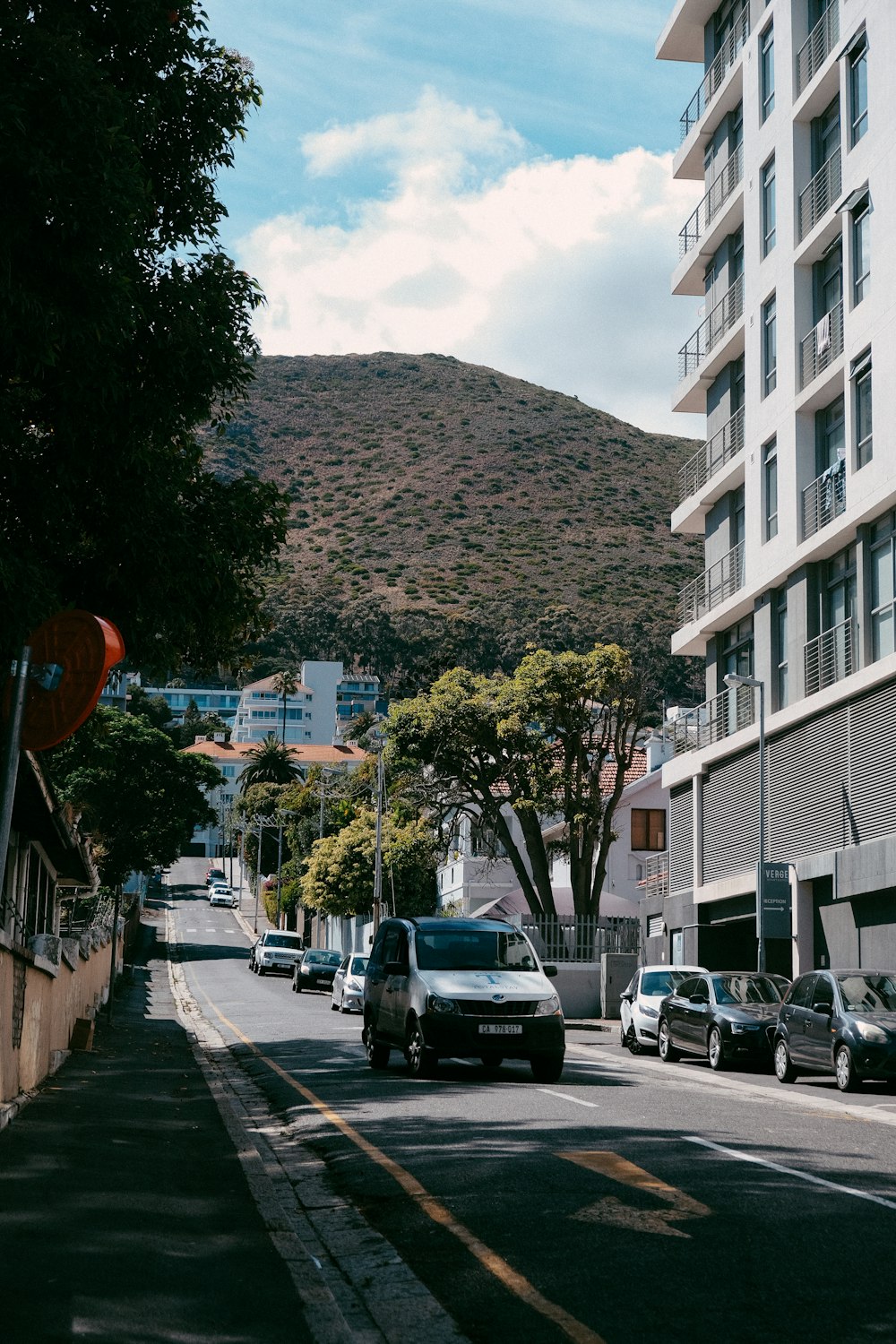 a street with cars and buildings on the side