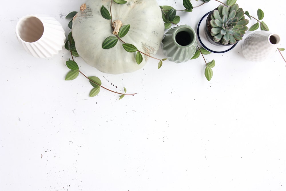 a pair of tea cups with tea leaves and saucers