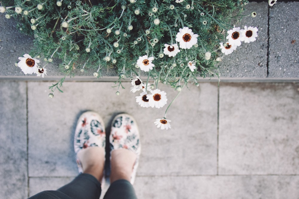 a pair of feet with flowers on them