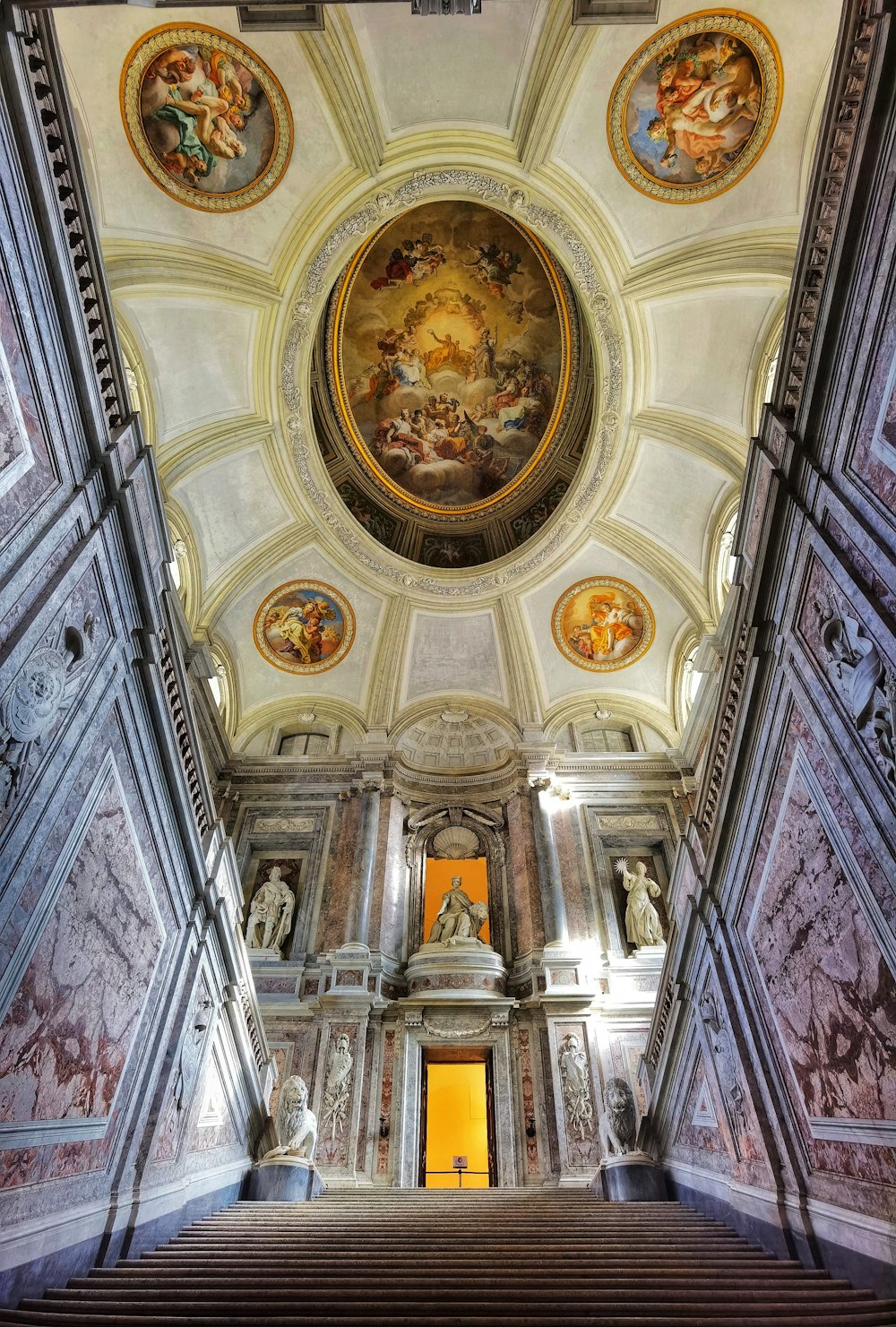 a large ornate room with paintings on the ceiling