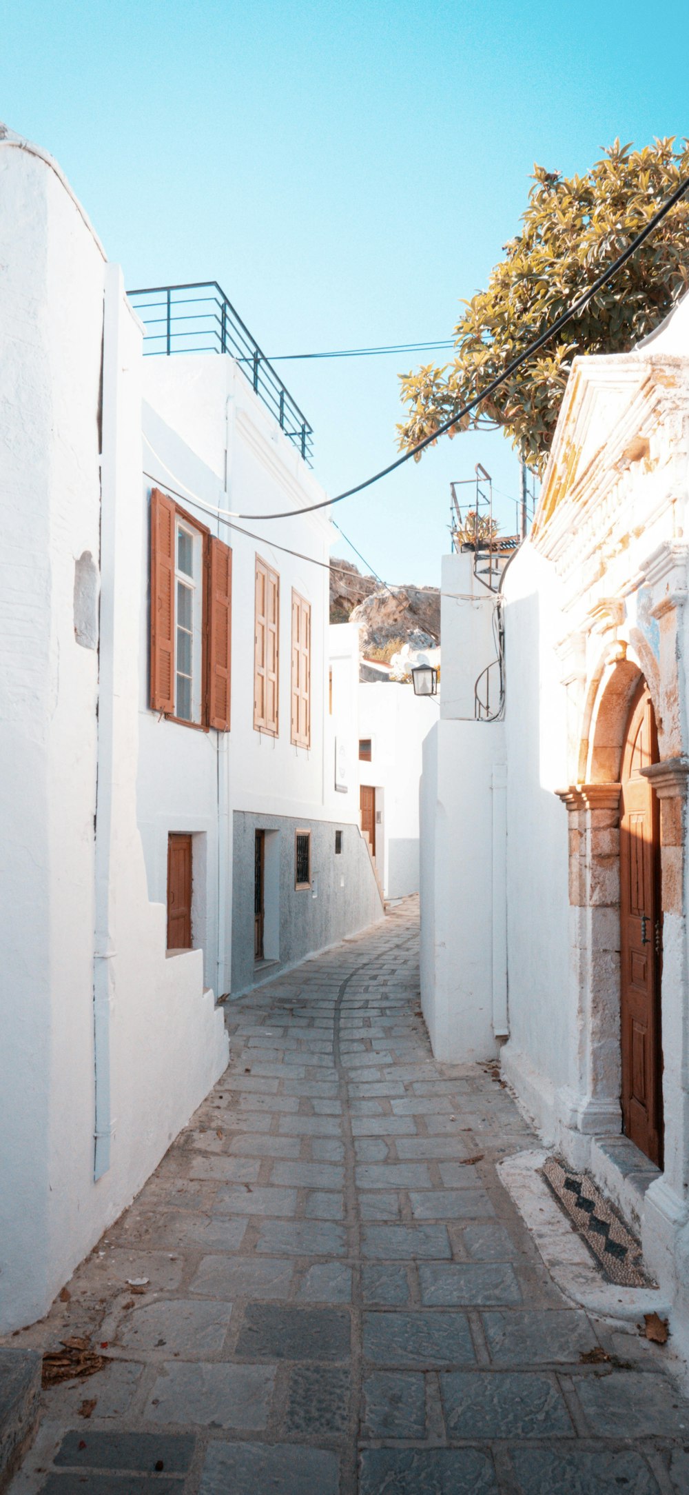 a stone street with white buildings