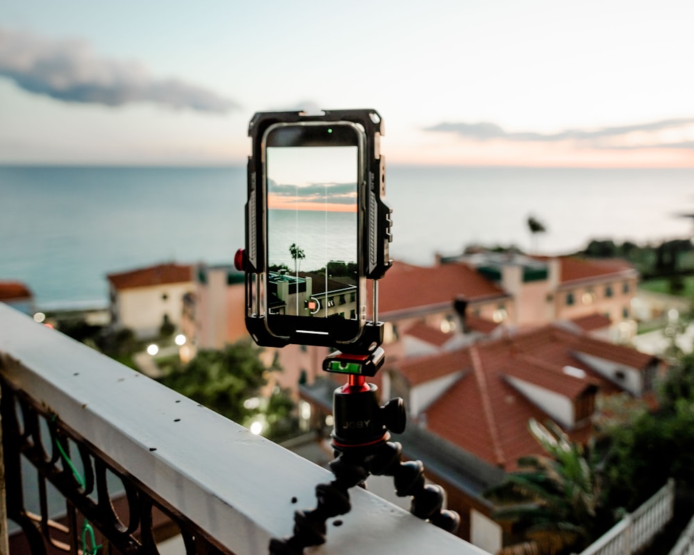 a gondola on a rooftop overlooking a town and the ocean