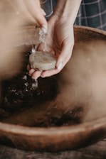 An artisan creating handmade soap in a serene workshop filled with natural ingredients.
