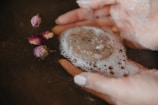 a close-up of a hand holding a mushroom
