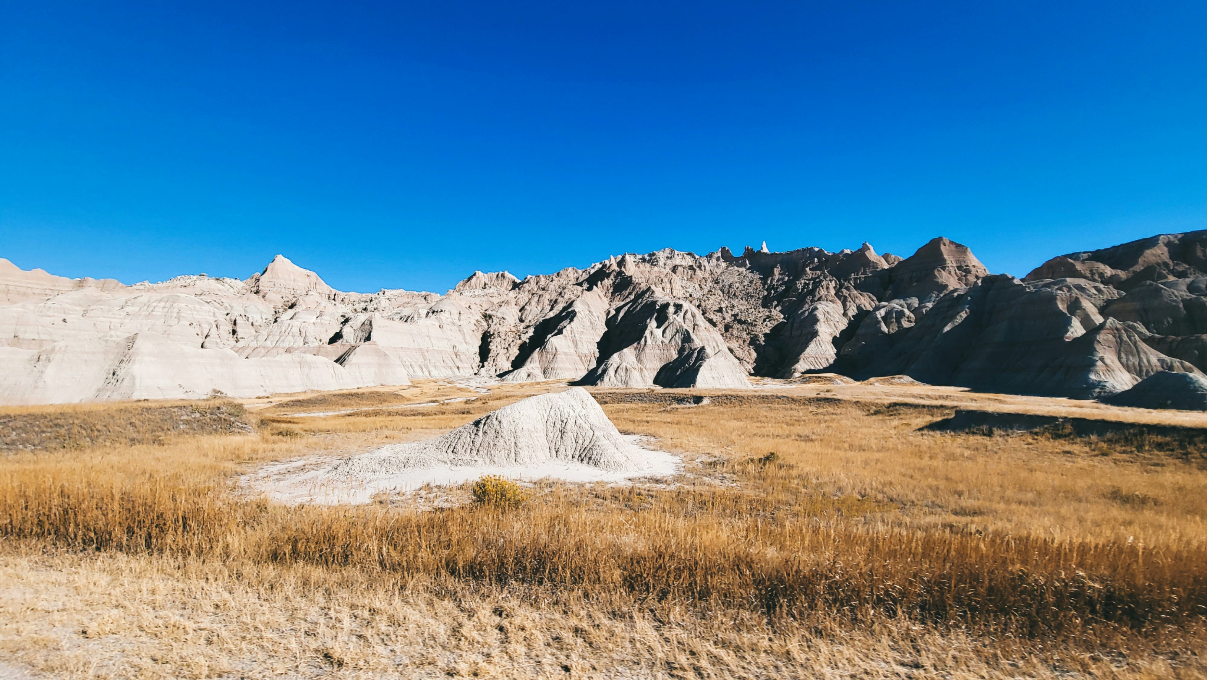 a desert landscape with a mountain in the distance