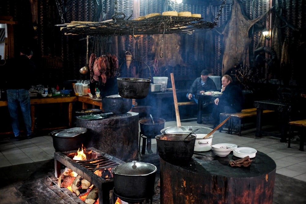 a group of people cooking in a kitchen