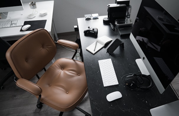 A modern workspace featuring a sleek coffee maker and tech gadgets on a clean desk.