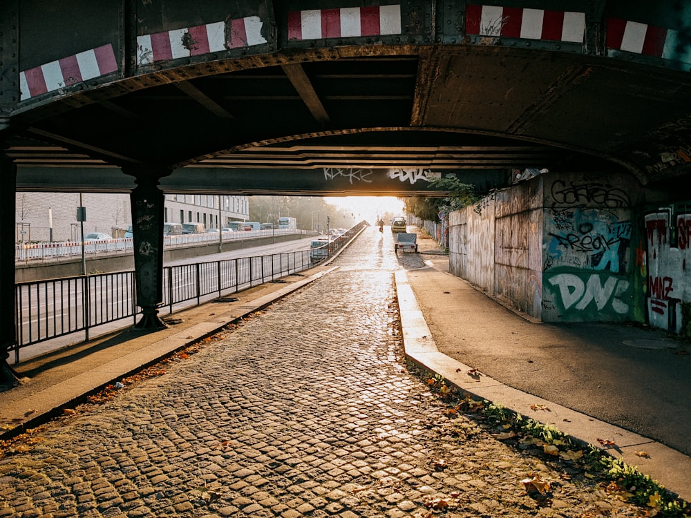 a walkway with graffiti on the walls