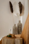a wall with a painting and a vase with a plant in it