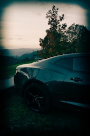 A sleek car parked ready for a journey with a scenic Bhubaneswar backdrop.