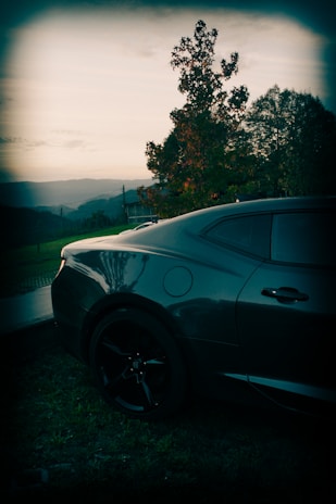 A stylish car parked against a scenic backdrop.