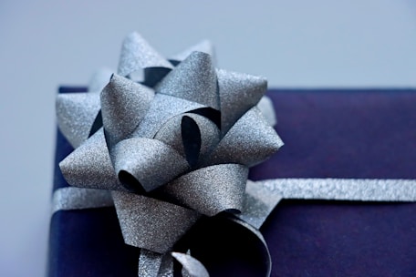 Close-up of colorful silk ribbons artistically tied around a gift box.