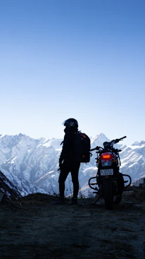 a man standing next to a motorcycle