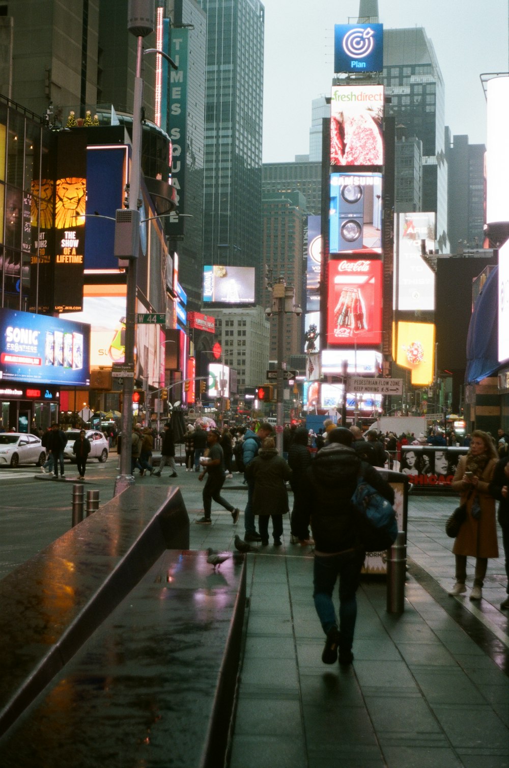 people walking on a sidewalk in a city