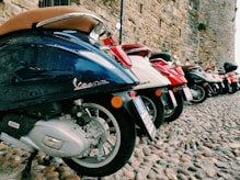 a row of motorcycles parked on rocks