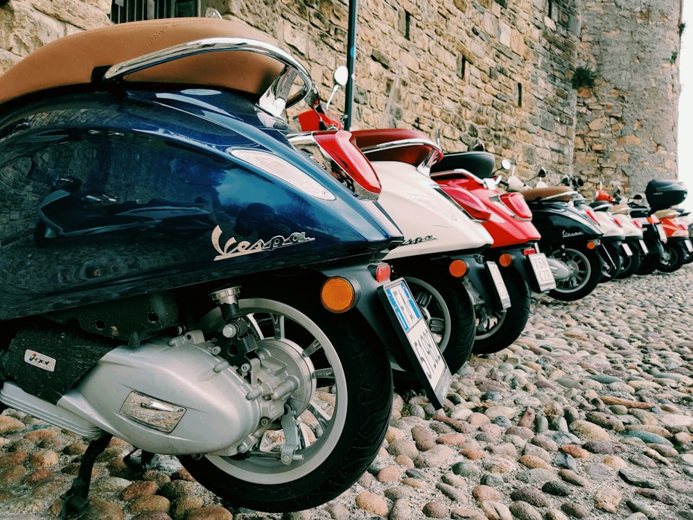 a row of motorcycles parked on rocks