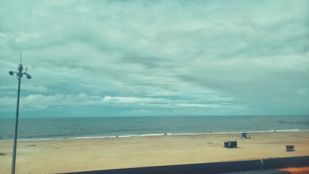 a beach with a wind turbine