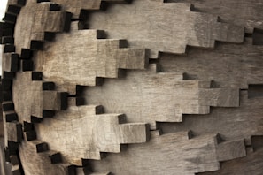 Close-up of a detailed 3D printed gear template resting on a wooden workbench.