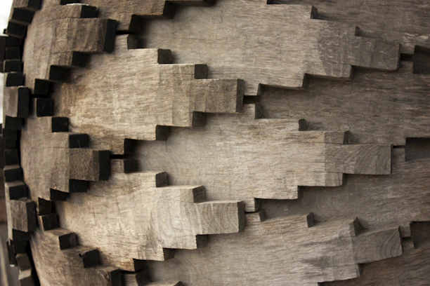 Close-up of a detailed 3D printed gear part resting on a wooden table.