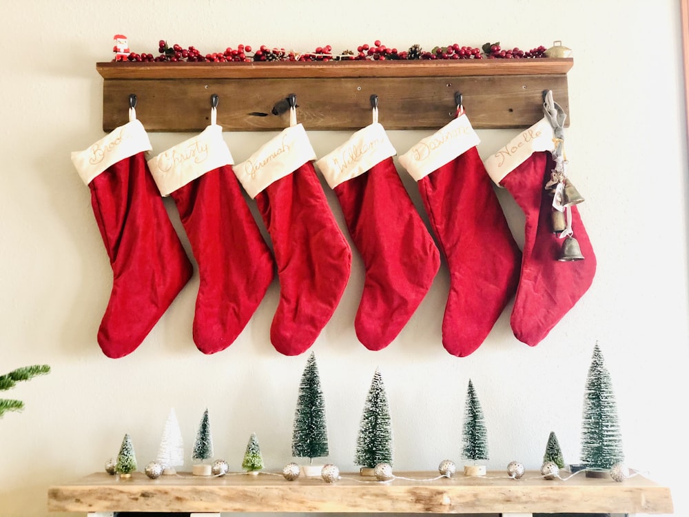 a group of red and white stockings from a wooden shelf