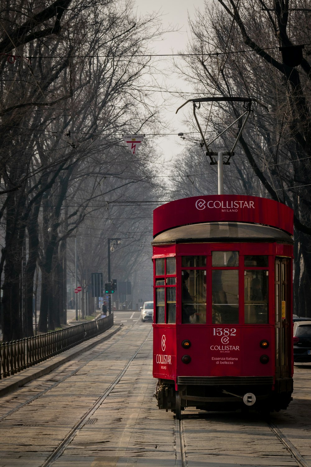 a red trolley car on a street
