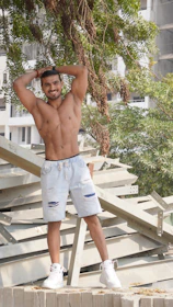 A confident businessman stretching after a quick calisthenics session outdoors.