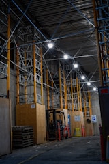 a large warehouse with a few lights