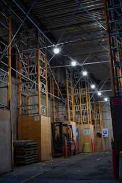 a large warehouse with a few lights