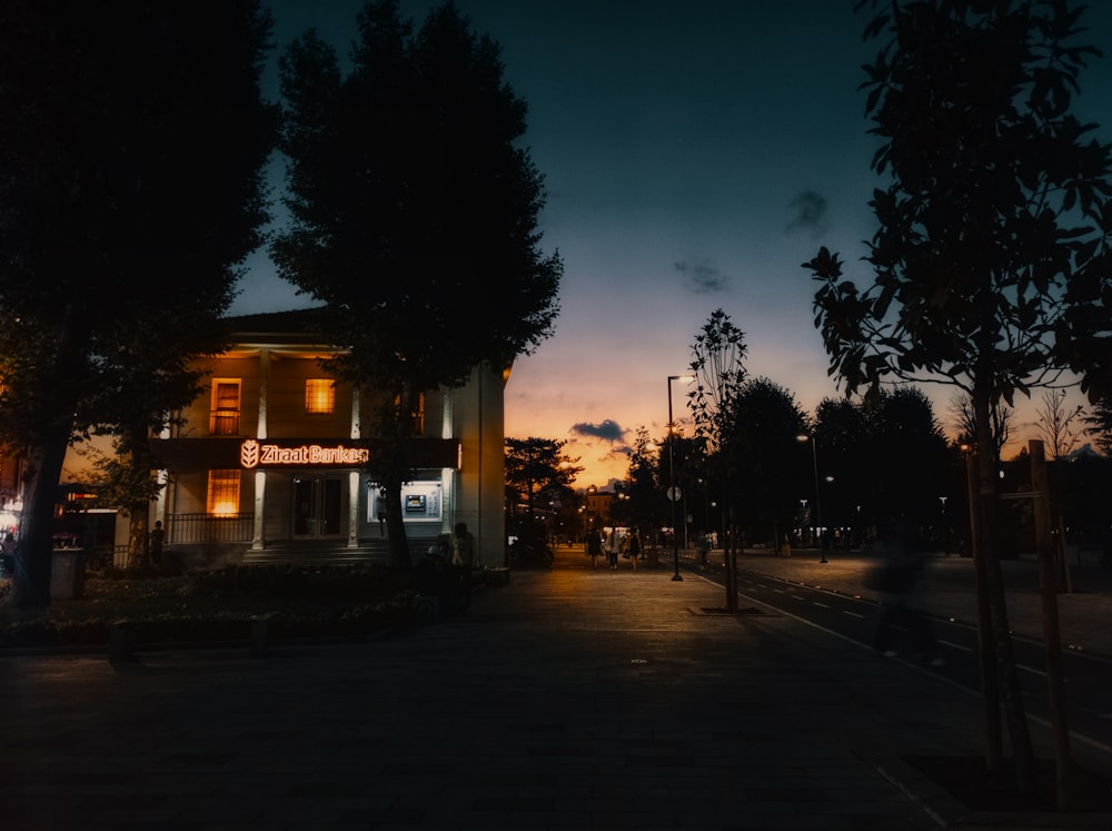 a street with trees and buildings on the side