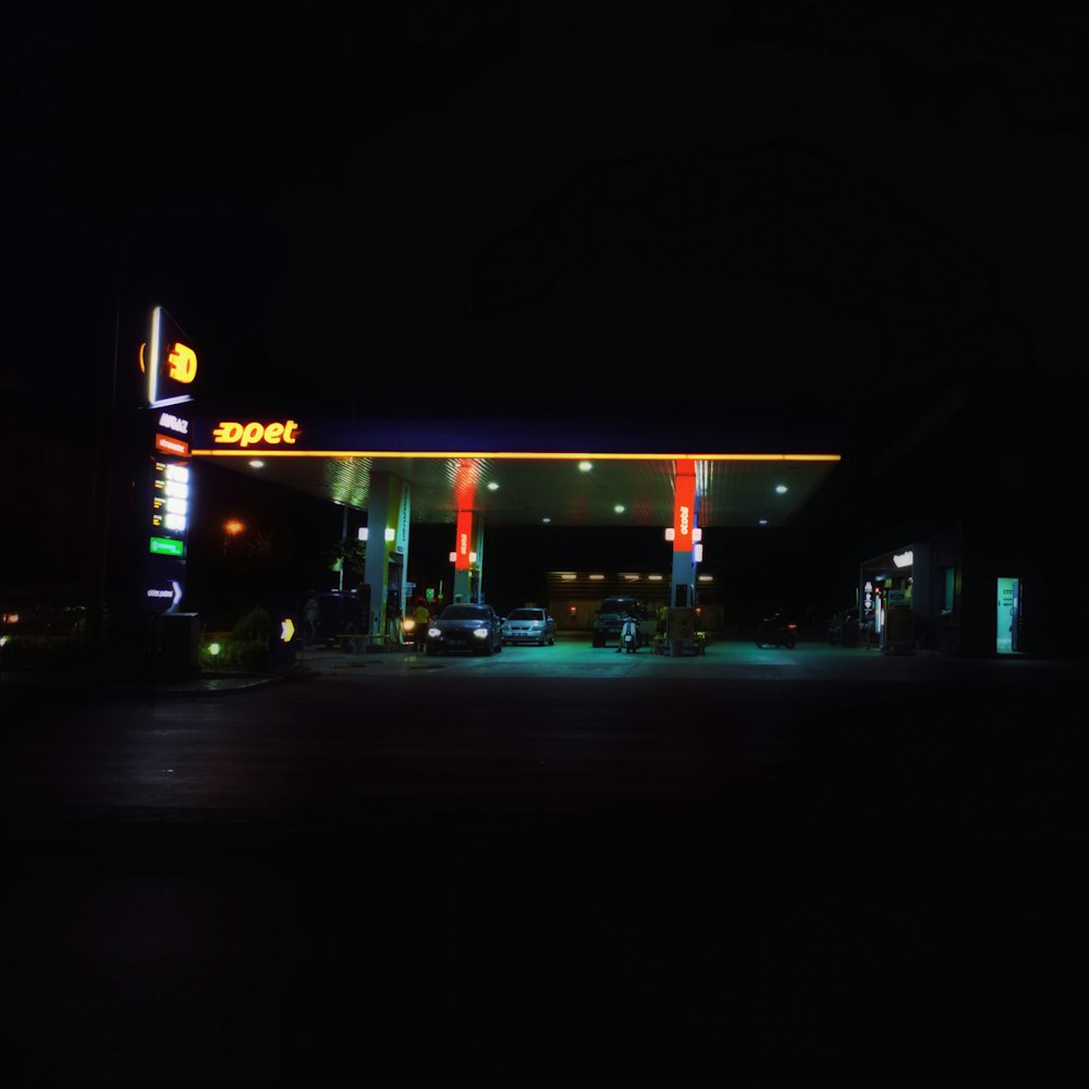 a street with cars and buildings at night