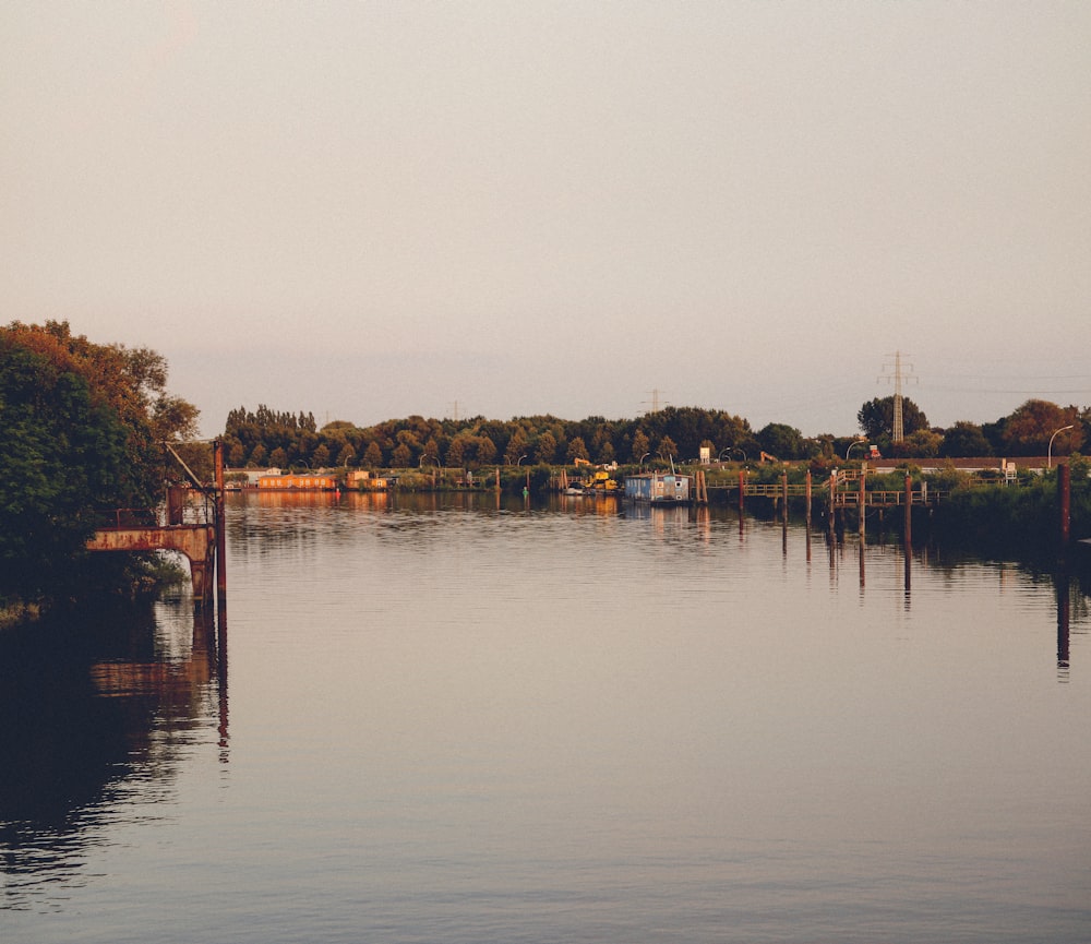 a body of water with a dock and buildings in the background