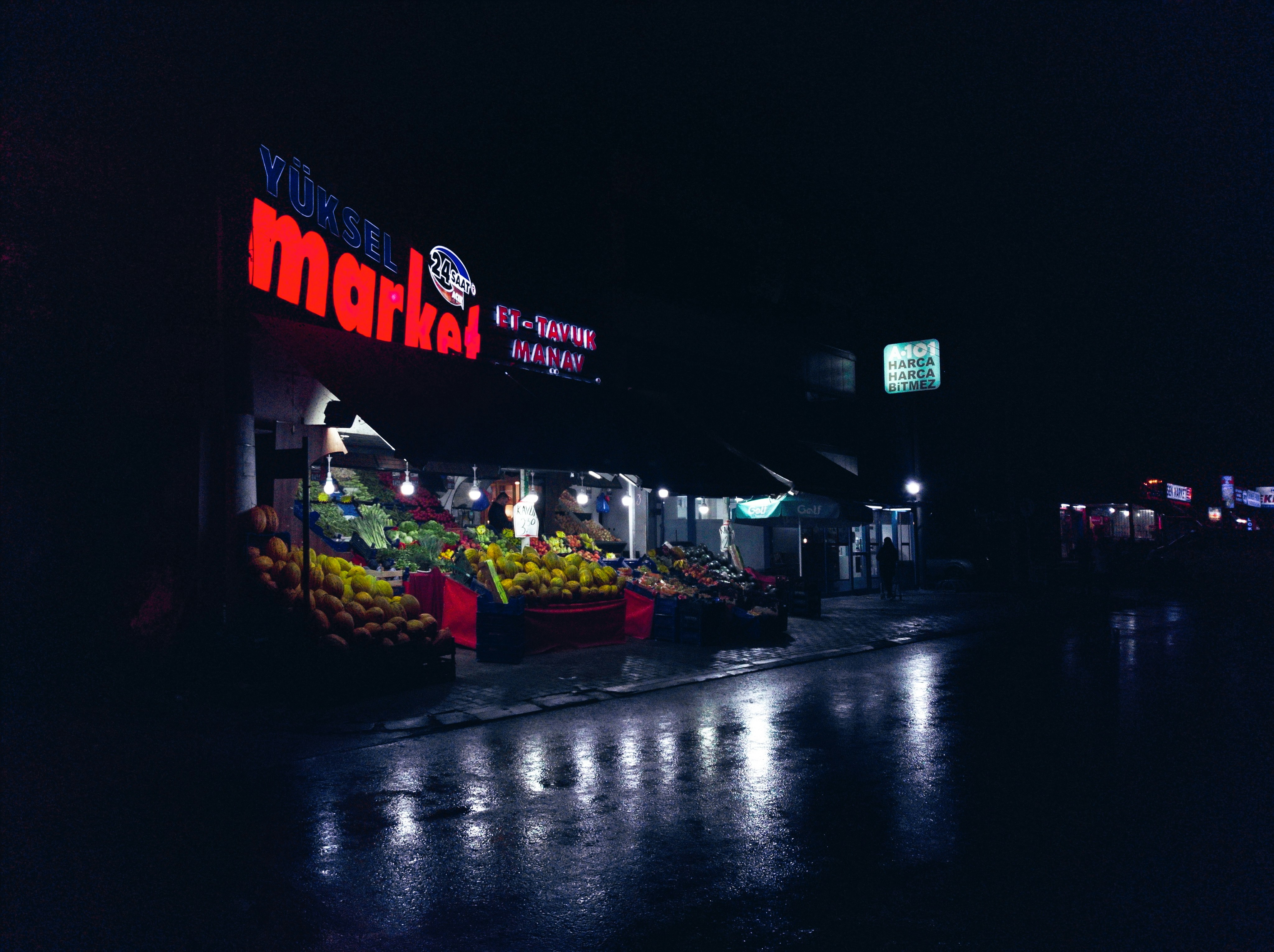 a fruit stand with a sign