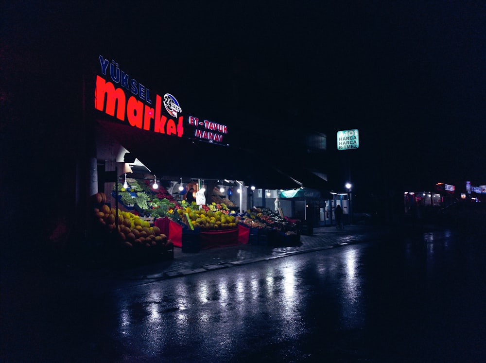 a fruit stand with a sign