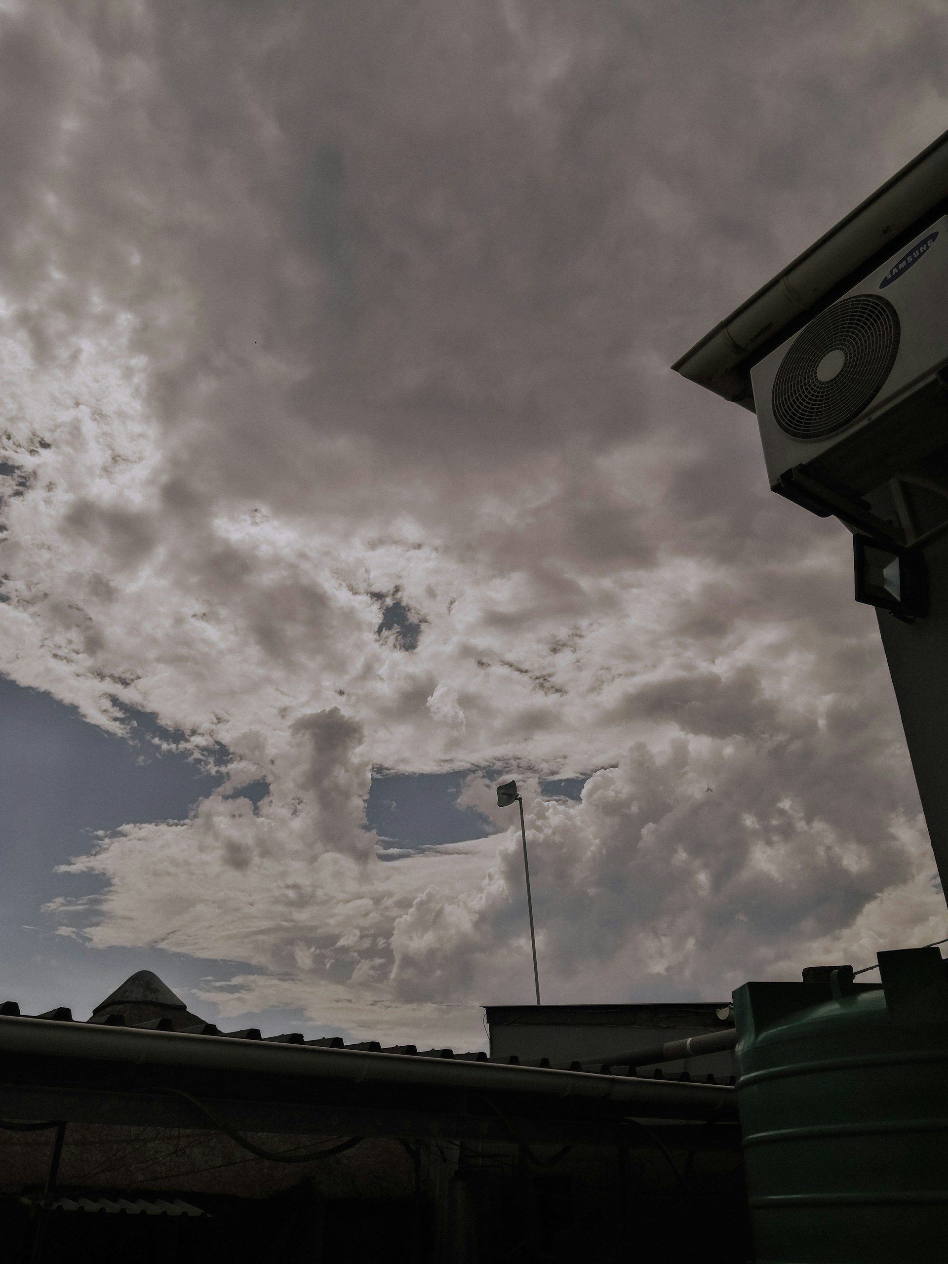 woman wearing yellow long-sleeved dress under white clouds and blue sky during daytime