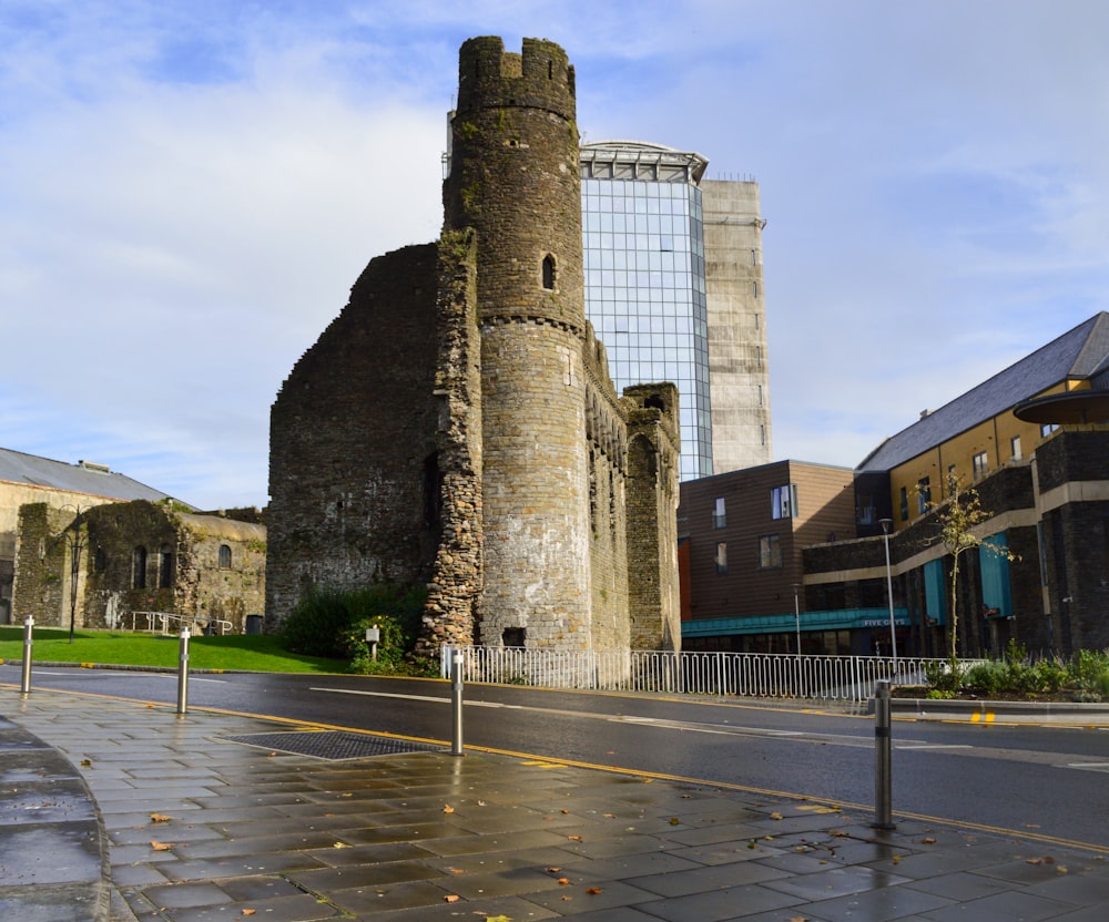 a stone castle with a fence around it